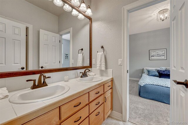 581 Stonemont Dr, Castle Pines, CO 80108 - full bathroom featuring double vanity, ensuite bath, and baseboards