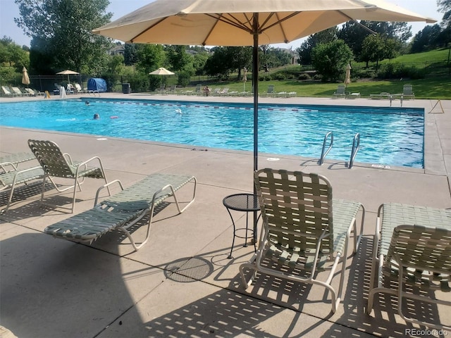 581 Stonemont Dr, Castle Pines, CO 80108 - community pool featuring a patio