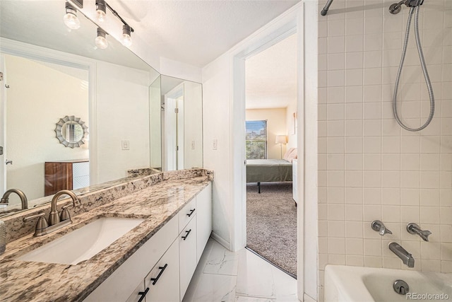 2 Acoma St Unit 11, Denver, CO 80223 - bathroom featuring marble look tile flooring, bathtub / shower combination, vanity, a textured ceiling, and ensuite bathroom