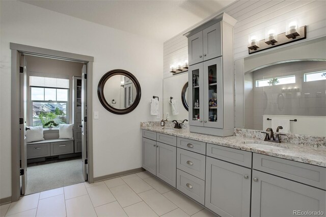 23451 E Rockinghorse Pkwy, Aurora, CO 80016 - full bathroom featuring double vanity and baseboards