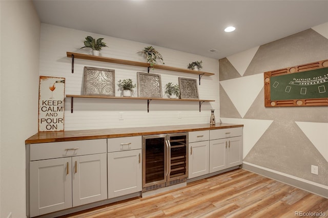 23451 E Rockinghorse Pkwy, Aurora, CO 80016 - indoor bar with beverage cooler, light wood-style floors, recessed lighting, and baseboards