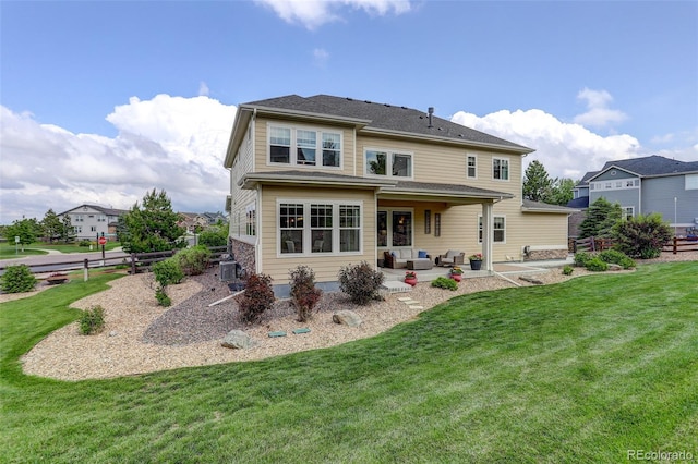23451 E Rockinghorse Pkwy, Aurora, CO 80016 - back of property with a patio area, an outdoor living space, and a yard