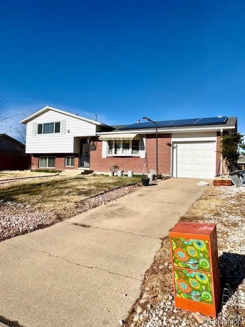 view of front of house featuring solar panels and a garage