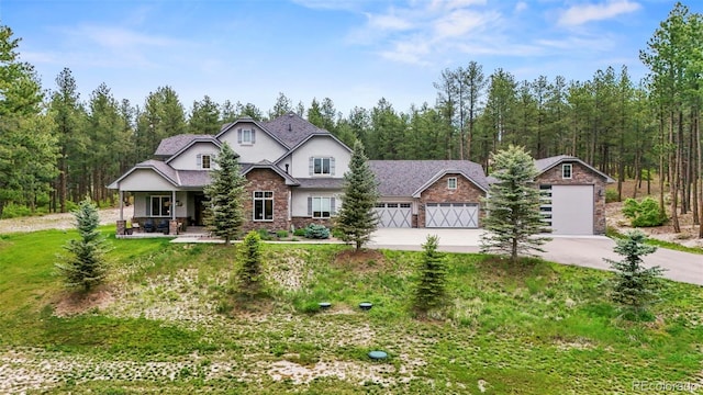 10525 Wild Fox Pl, Franktown, CO 80116 - craftsman-style home featuring driveway, stone siding, covered porch, a front lawn, and stucco siding
