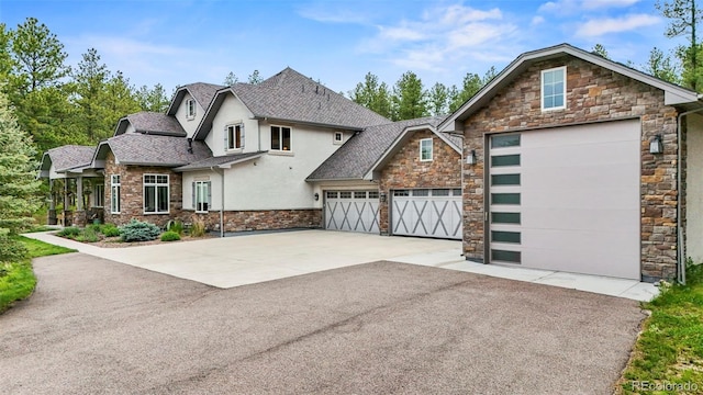 10525 Wild Fox Pl, Franktown, CO 80116 - view of front of property featuring stone siding, stucco siding, asphalt driveway, and a shingled roof