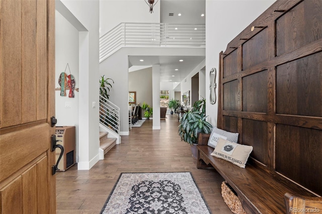 10525 Wild Fox Pl, Franktown, CO 80116 - entrance foyer featuring wood finished floors, stairway, a towering ceiling, recessed lighting, and heating unit