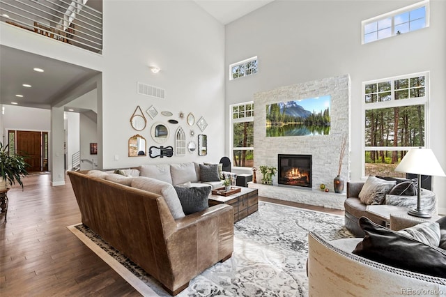 10525 Wild Fox Pl, Franktown, CO 80116 - living room with a towering ceiling, plenty of natural light, a fireplace, and wood finished floors