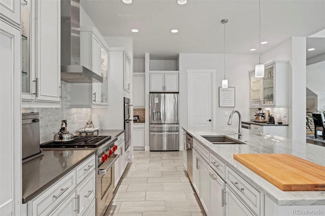 10525 Wild Fox Pl, Franktown, CO 80116 - kitchen featuring appliances with stainless steel finishes, wall chimney exhaust hood, tasteful backsplash, recessed lighting, and white cabinetry