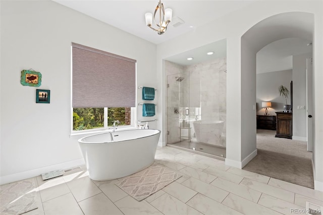 10525 Wild Fox Pl, Franktown, CO 80116 - bathroom with a shower stall, a freestanding tub, marble look tiles, and recessed lighting
