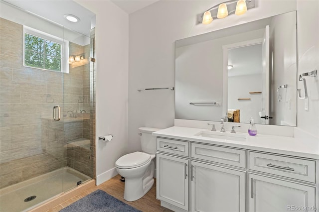 10525 Wild Fox Pl, Franktown, CO 80116 - bathroom featuring vanity, a stall shower, and wood finished floors