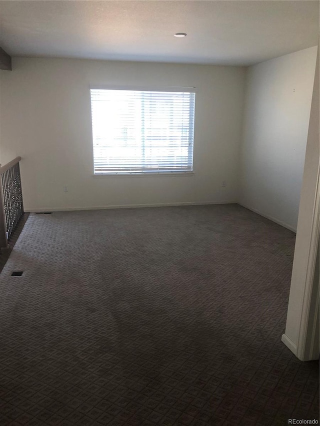 empty room with dark carpet