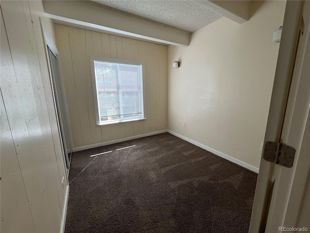 9995 E Harvard Ave Unit 261, Denver, CO 80231 - empty room featuring dark carpet and a textured ceiling