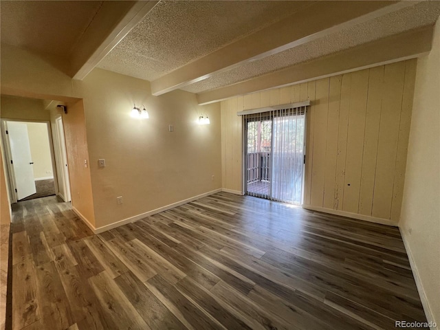9995 E Harvard Ave Unit 261, Denver, CO 80231 - unfurnished room featuring beamed ceiling, wood finished floors, a textured ceiling, and wooden walls
