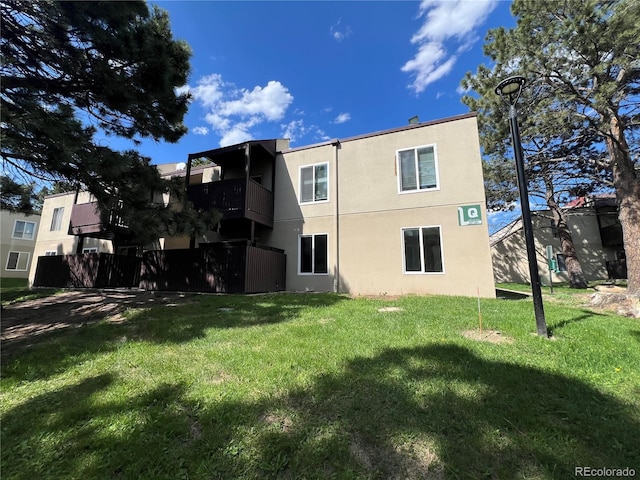 9995 E Harvard Ave Unit 261, Denver, CO 80231 - back of property with stucco siding and a yard