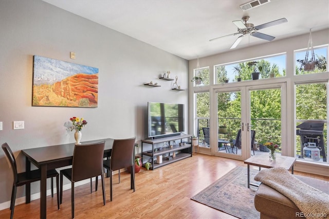 living room featuring ceiling fan, light hardwood / wood-style floors, and french doors