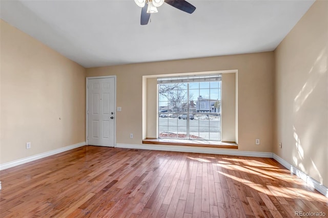 spare room with ceiling fan and light wood-type flooring