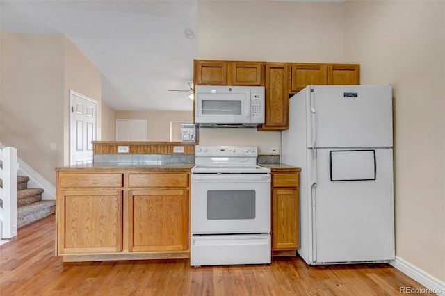 kitchen featuring ceiling fan, light wood-type flooring, and white appliances