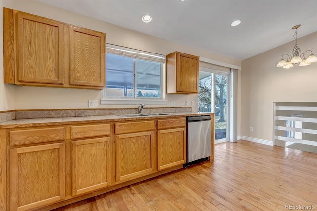 kitchen featuring sink, light hardwood / wood-style flooring, stainless steel dishwasher, a notable chandelier, and pendant lighting