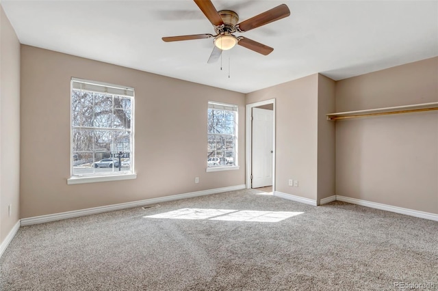 unfurnished bedroom featuring light colored carpet, ceiling fan, and a closet