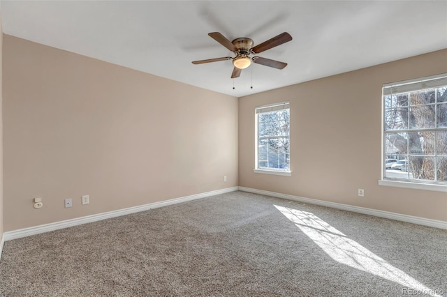 spare room featuring ceiling fan and carpet