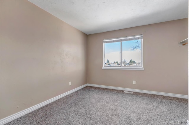 unfurnished room featuring carpet