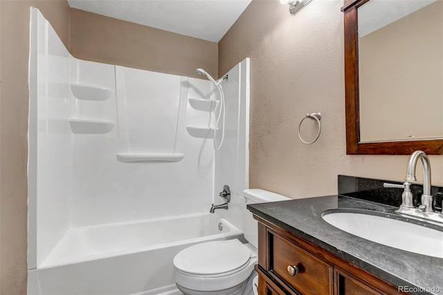 full bathroom featuring vanity, washtub / shower combination, and toilet