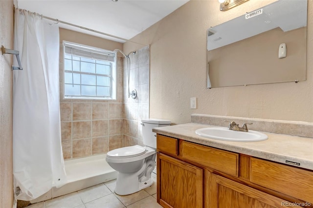 bathroom with vanity, tile patterned flooring, curtained shower, and toilet