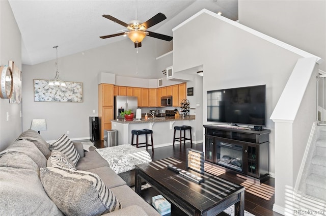 living room with high vaulted ceiling, dark hardwood / wood-style floors, and ceiling fan