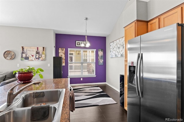 kitchen featuring sink, dark hardwood / wood-style flooring, stainless steel fridge with ice dispenser, and hanging light fixtures