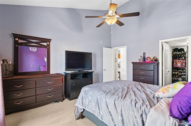 bedroom with light carpet, a towering ceiling, and ceiling fan