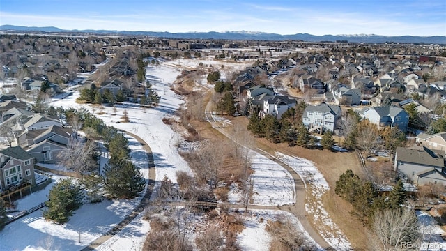 snowy aerial view with a mountain view