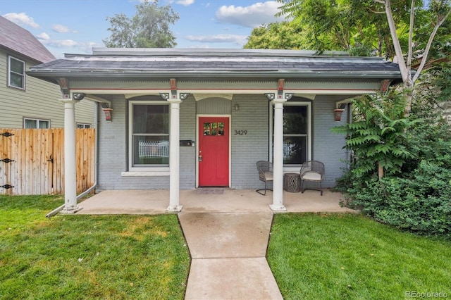 3429 N Adams St, Denver, CO 80205 - view of front facade featuring brick siding, covered porch, and a shingled roof