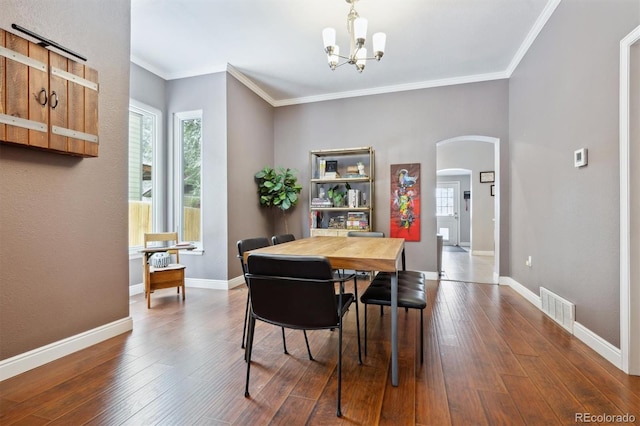 3429 N Adams St, Denver, CO 80205 - dining room featuring arched walkways, a chandelier, dark wood finished floors, and crown molding