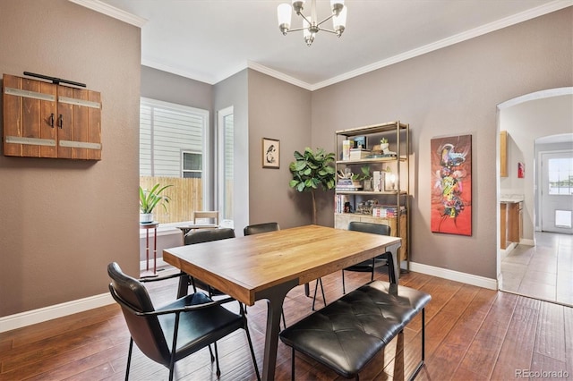 3429 N Adams St, Denver, CO 80205 - dining space featuring arched walkways, wood-type flooring, ornamental molding, and a chandelier