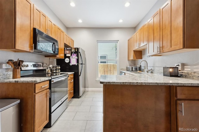 3429 N Adams St, Denver, CO 80205 - kitchen with stainless steel electric range oven, black microwave, a peninsula, light stone counters, and light tile patterned flooring