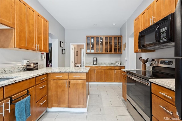3429 N Adams St, Denver, CO 80205 - kitchen featuring stainless steel range with electric cooktop, black microwave, glass insert cabinets, light tile patterned floors, and light stone countertops