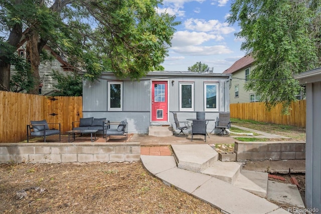 3429 N Adams St, Denver, CO 80205 - back of property featuring entry steps, a patio, a fenced backyard, and an outdoor living space