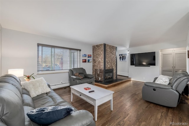 living room featuring a large fireplace, a baseboard heating unit, and wood finished floors