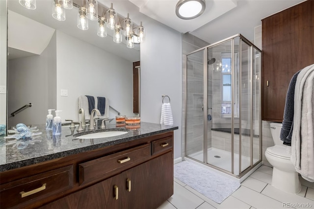 bathroom featuring toilet, a shower stall, vanity, and tile patterned floors