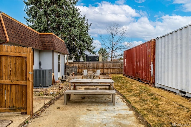 view of yard featuring a fenced backyard, a patio, and central AC unit