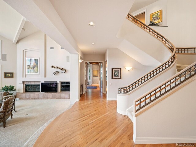 foyer featuring hardwood / wood-style flooring and a tiled fireplace