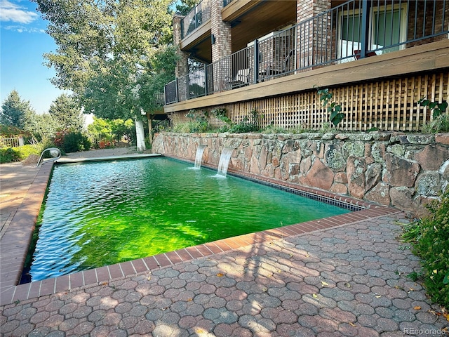 view of swimming pool featuring pool water feature