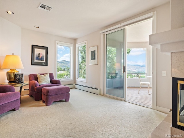 living room featuring light carpet, baseboard heating, and a high end fireplace