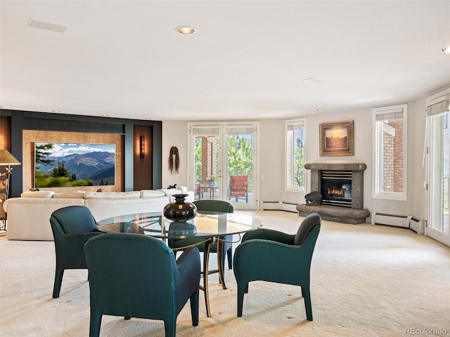 dining area featuring a baseboard heating unit, carpet, recessed lighting, and a premium fireplace