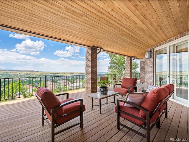 wooden deck with an outdoor living space