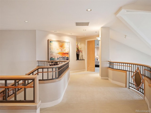 hallway featuring visible vents, baseboards, an upstairs landing, and recessed lighting