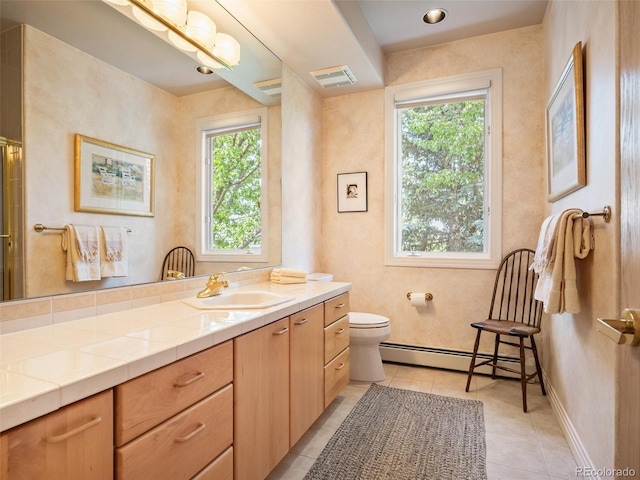 full bath featuring toilet, plenty of natural light, baseboard heating, and vanity