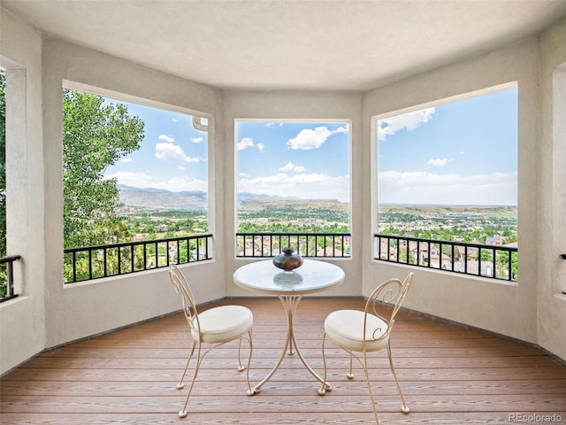 sunroom / solarium featuring a mountain view