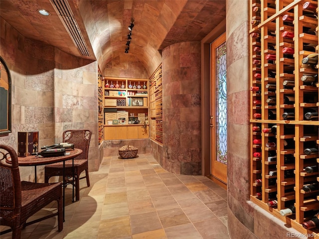 wine area featuring vaulted ceiling