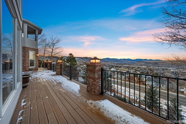 snow covered deck featuring a mountain view